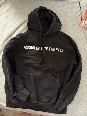 Black Graphic Hoodie with 'ASSHOLES LIVE FOREVER' Print
